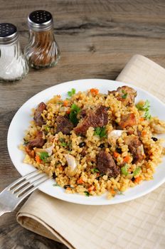 Pilaf   from bulgur with meat, vegetables and barberry