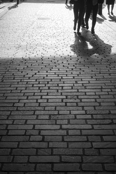 commuters walking down a cobbled lane in london city