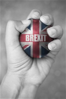 Hand squeezing a stress ball with brexit 