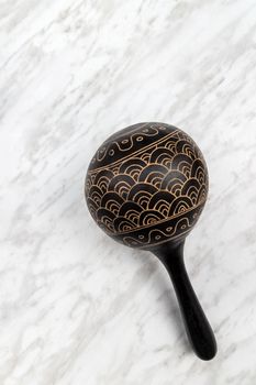 Maracas, traditional percussion instrument on marble background.