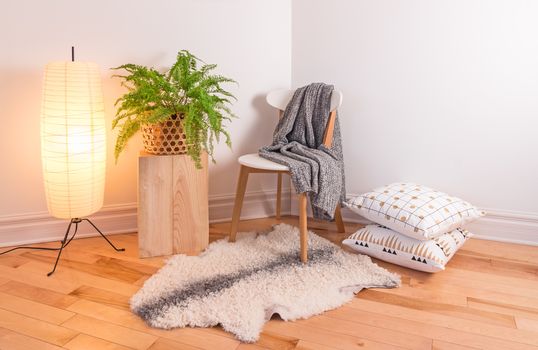 Room with cozy light decorated in Scandinavian style, using natural materials.