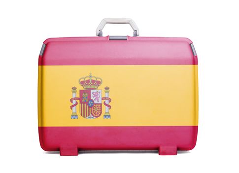 Used plastic suitcase with stains and scratches, printed with flag, Spain