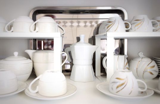Cups on the white shelves in the store