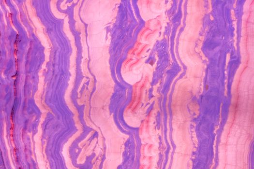 Natural stone glass background pattern of multicolored stripes purple pink