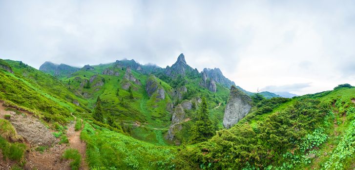 Hikers going to Mount Ciucas peack on summer, part of the Carpathian Range from Romania