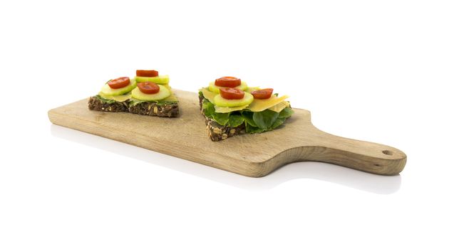 healthy breakfast or lunch with bread with cucumber salade tomato and cheese isolated on white background