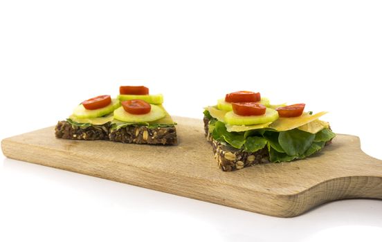 healthy breakfast or lunch with bread with cucumber salade tomato and cheese isolated on white background