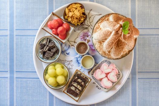 top view of Bingsu on tray served with mix  sweet topping , fruits and baked