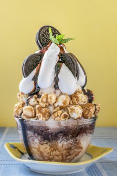 Bingsu - Korean shaved ice dessert with sweet toppings with chocolate cookies and popcorns