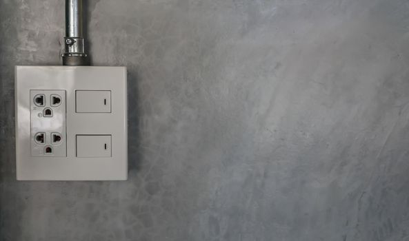 electric plug and switch on gray wall