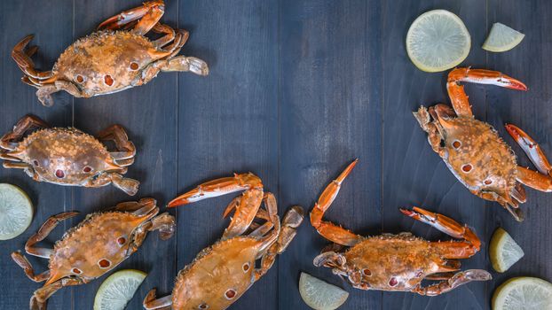 Food frame with crustacean . crab on wooden background