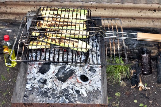almost finished, fried until Golden brown zucchini on a grill over hot coals, visible red coals