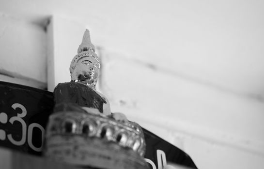 BLACK AND WHITE PHOTO OF BUDDHA STATUE FOCUS ON FACE