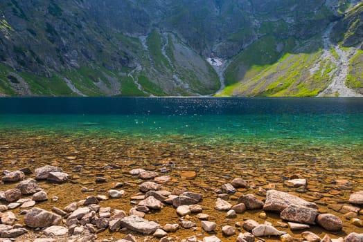 the purest mountain lake Czarny Staw on a sunny day in the Tatras, Poland