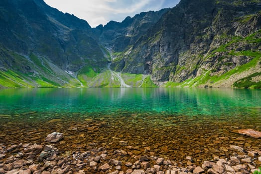 a cold picturesque mountain lake Czarny Staw in the high Tatra mountains in Poland