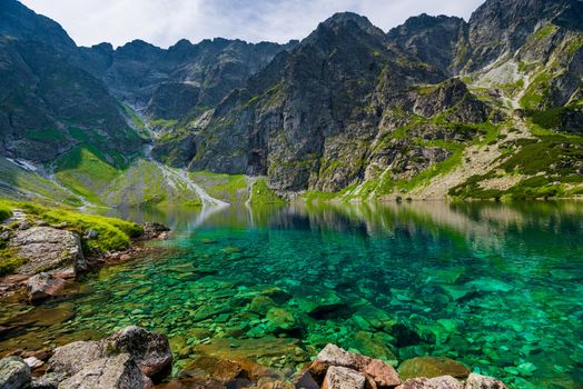 transparent water of a clean mountain lake Czarny Staw in the Tatras