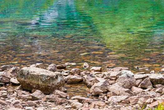 shore of a mountain lake - close-up stones and water