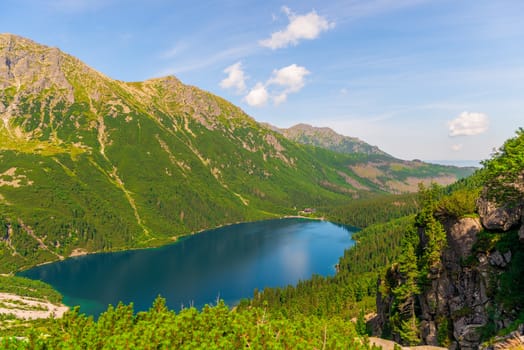 View from the mountain to the beautiful scenic Lake Morskie Oko on a sunny summer day