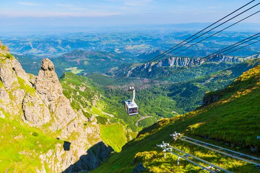 cable car on ropes, going to the mountain Kasprowy Ver, Poland. Beautiful view of the valley