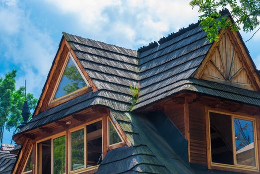 upper floor of a village house with a wooden roof on a background of a close-up sky