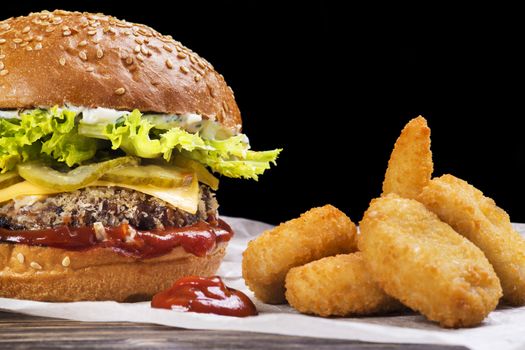 Craft beef burger and french fries on wooden table