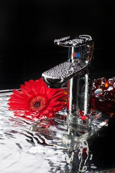 Metal chromium-plated mixer for wwater on a studio background