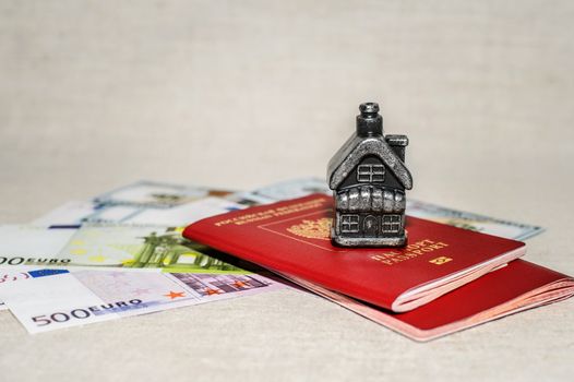Passport, money and home - the concept of buying a property.