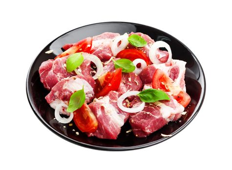 Uncooked shish kebab on plate. Raw pork barbecue isolated on white background with clipping path