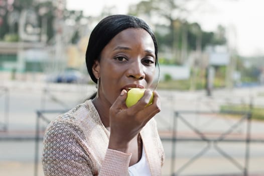 This young woman is eating an apple because it is nutritions.