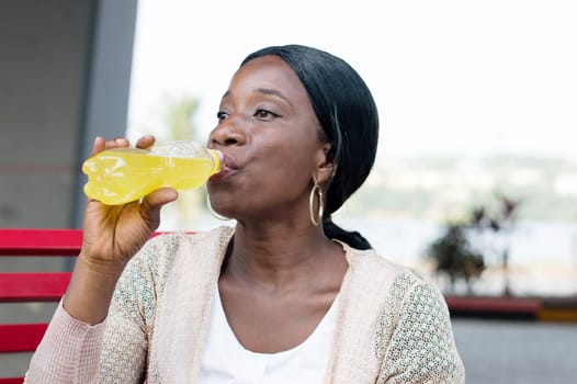 young woman so thirsty , she prefers to drink the sweet drink.