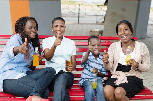 These young woman and little boy sitting on a bench.