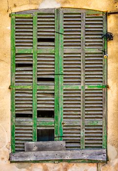 Abstract Rustic Background Of Old Broken Window Shutters On A Spanish Villa