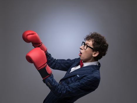 Businessman in boxing gloves falling in knockout