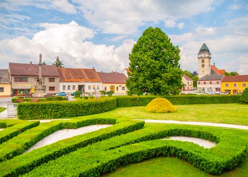 Town park greenery and church of Saint Lawrence in Dacice, Czech Republic.