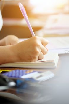close up female hands of accountant with calculator and pen. business accounting background.