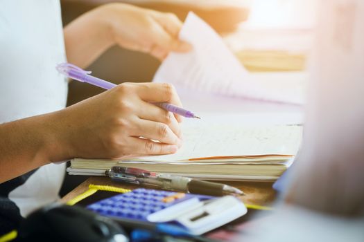 close up female hands of accountant with calculator and pen. business accounting background.