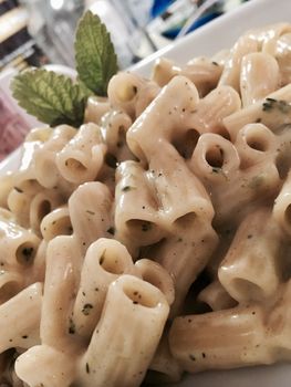 Delicious and fresh pasta with sauce, broccoli and chives.