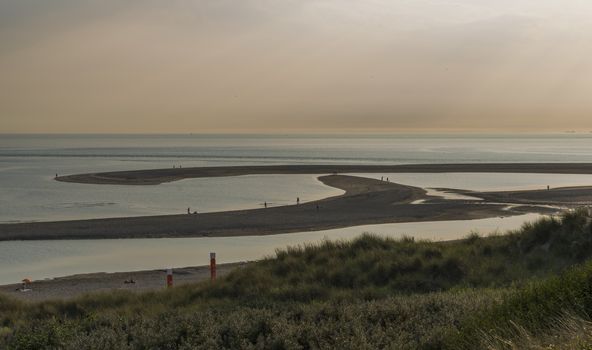 Rotterdam,Holland,16-july-2018:People late at the day waiting for sunset at the Maasvlakte beach, at eight o clock it is still 28 deg celcius this year