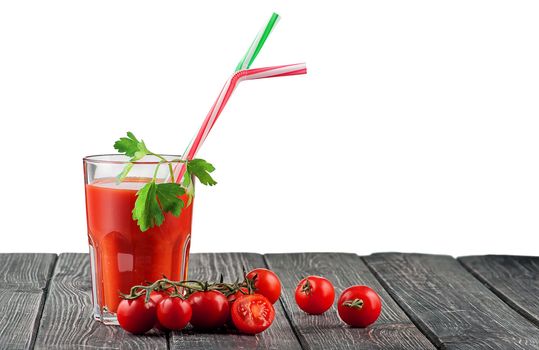 Glass of tomato juice with a cocktail stick. Cherry tomatoes on a wooden table near. Isolated on white background.