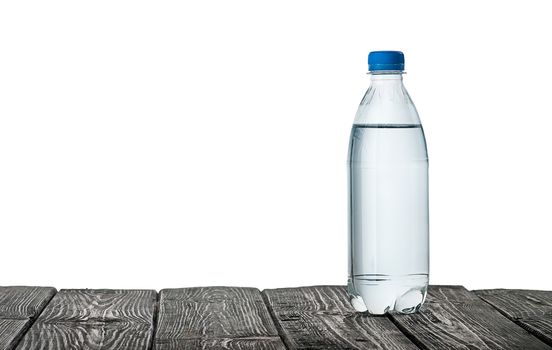 Plastic bottle of water on the table isolated on white background