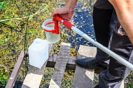 Take samples of water for laboratory testing. The concept - analysis of water purity, environment, ecology
