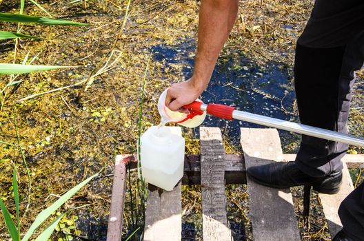 Take samples of water for laboratory testing. The concept - analysis of water purity, environment, ecology