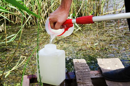 Take samples of water for laboratory testing. The concept - analysis of water purity, environment, ecology