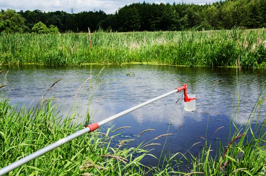 Take samples of water for laboratory testing. The concept - analysis of water purity, environment, ecology