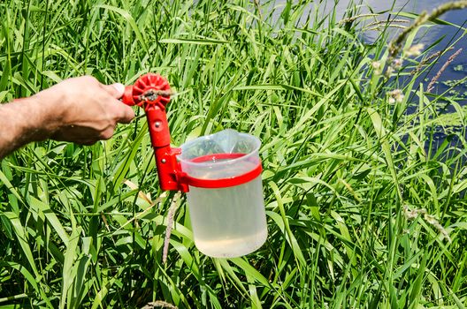 Take samples of water for laboratory testing. The concept - analysis of water purity, environment, ecology
