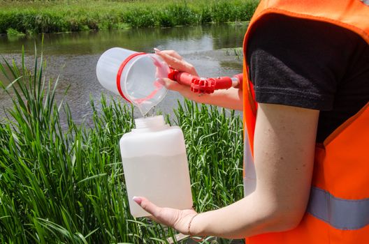 Take samples of water for laboratory testing. The concept - analysis of water purity, environment, ecology