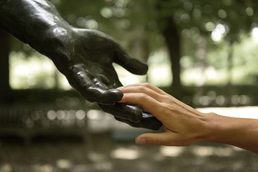 Rodin statue with sensitive human hands in a garden of the Rodin Museum, Paris, France.