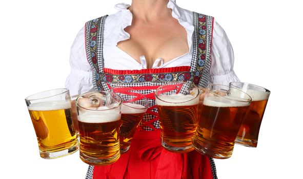 Young sexy woman wearing a dirndl with beer mugs isolated on white background, Oktoberfest concept