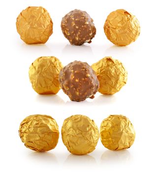 Sweet chocolate candy wrapped in golden foil isolated on white background