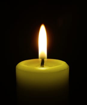 Candle on black background